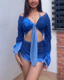 A three-piece swimsuit set consisting of crisscross strap Cover-Ups, a bikini and a drawstring swim skirt.